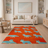 Playful Blue Foxes on Vibrant Orange Area Rug
