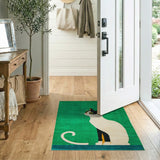 Playful Black Cat on Vibrant Green Area Rug