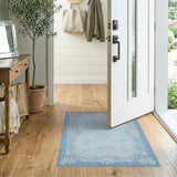 Elegant Blue Rug with Ornate White Floral Border