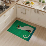 Playful Black Cat on Vibrant Green Area Rug